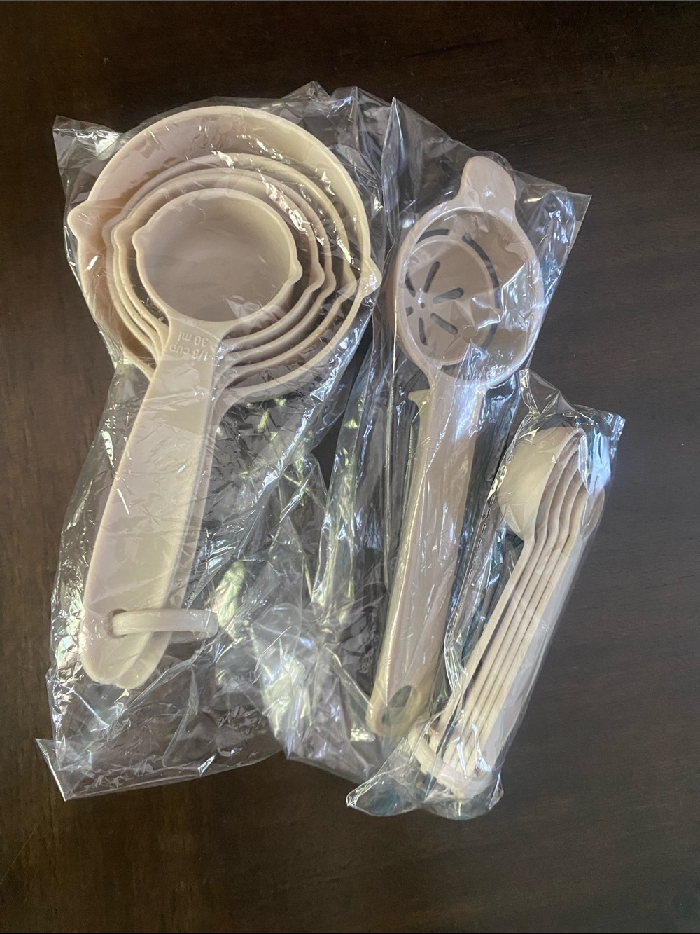 Set of Beige Measuring Cups and Spoons with Strainer